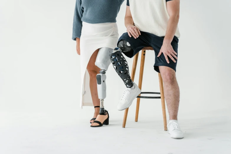 a couple sitting on stools posing for the camera