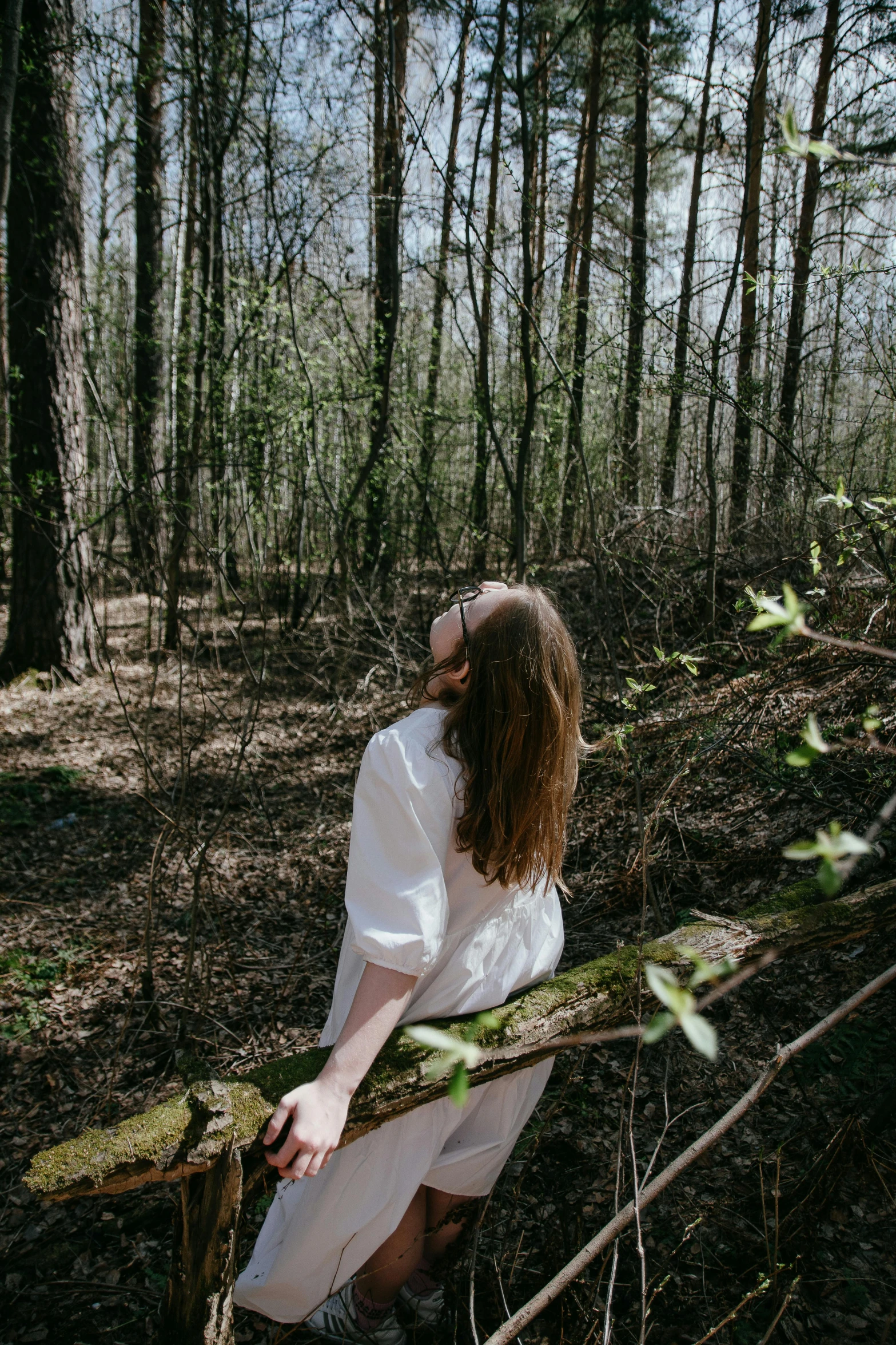 a person that is leaning up against a tree