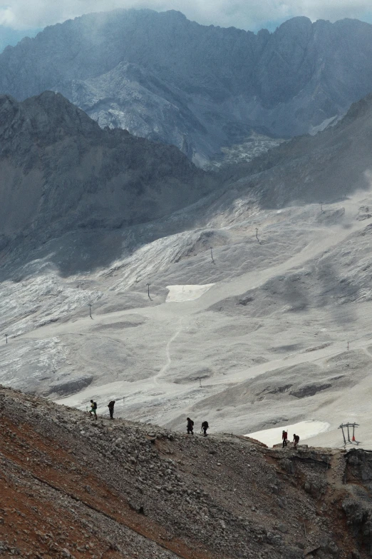 a group of people walking up a mountain side