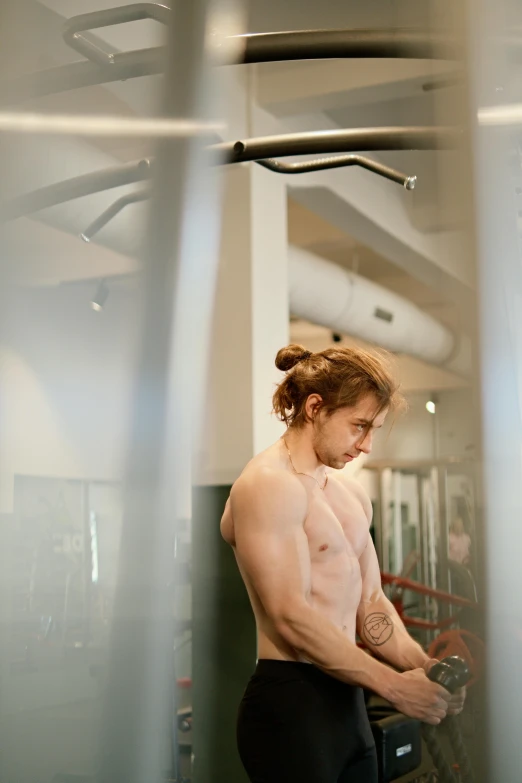 the man is using his hand weights in a gym