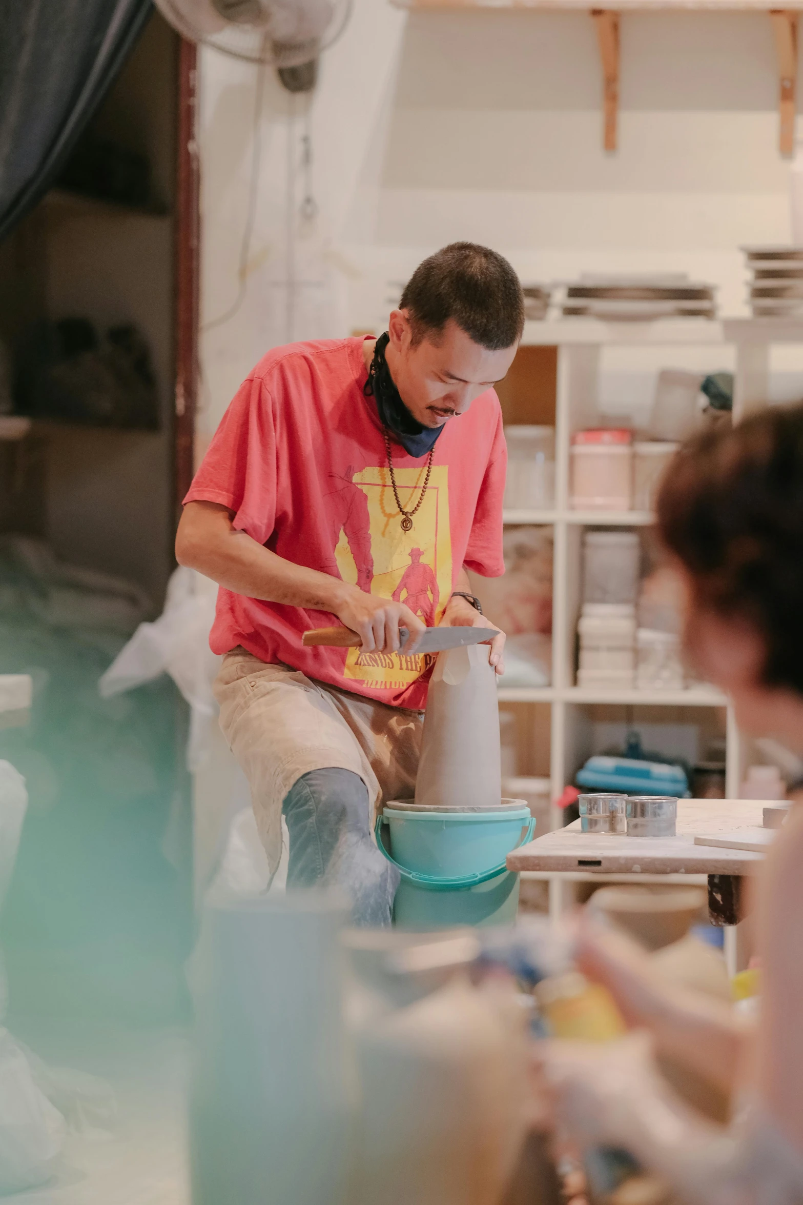 two people preparing ceramic pottery items in a craft workshop