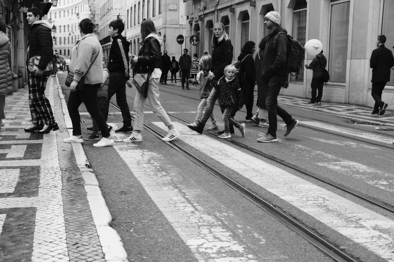 a group of people standing on the sidewalk