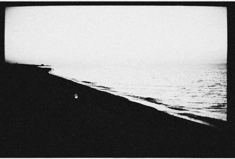 the person is alone walking alone on the beach