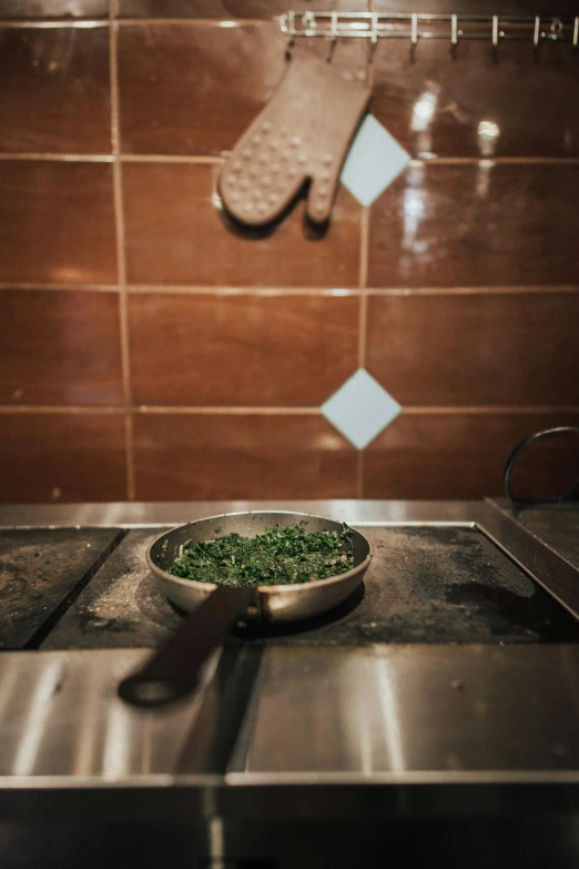 the plate is being placed on the stove and is next to a glove