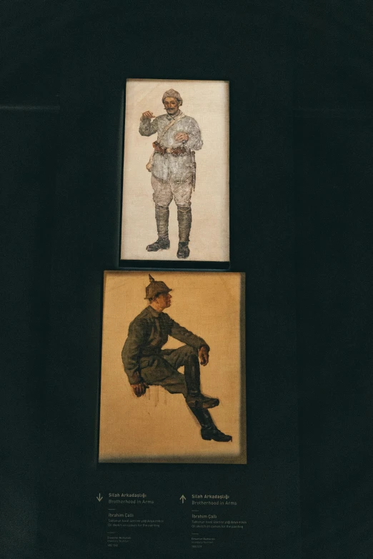 two framed portraits of men, one of them wearing a hat and one of which is on display