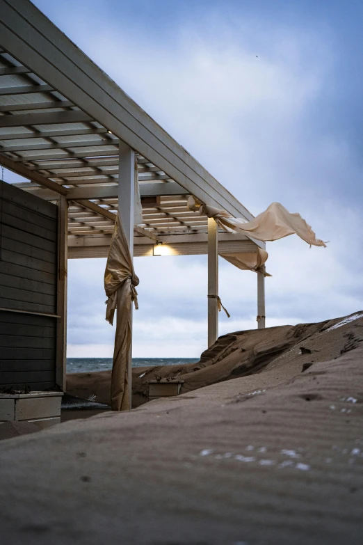 there is a open umbrella standing on the beach