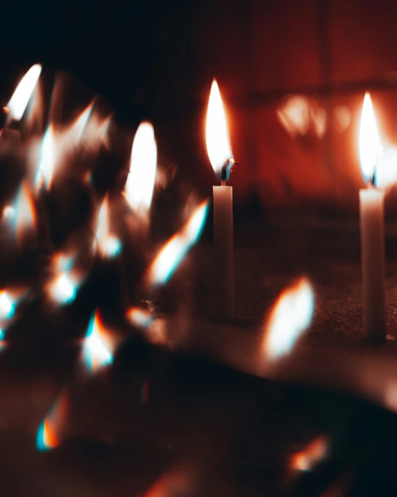 a close up of many small candles in a room