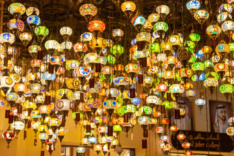 colorful glass hanging on a ceiling above a bar