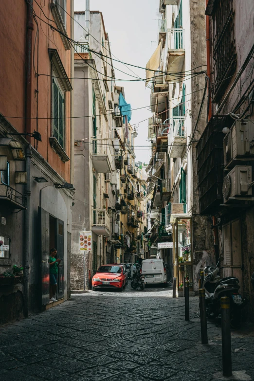 a car driving down an alley with old buildings