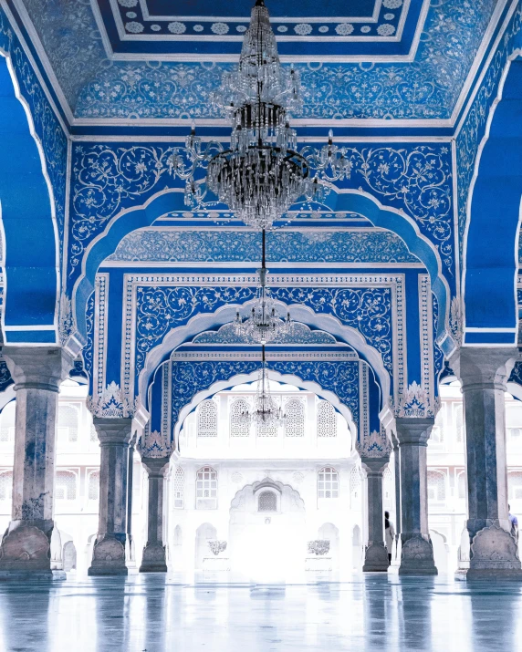 a blue archway with chandeliers on each side