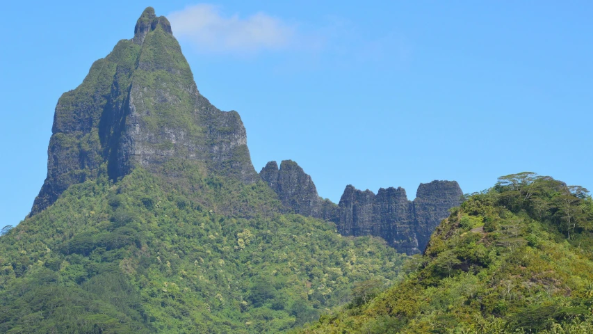 two large mountain peaks towering over a jungle