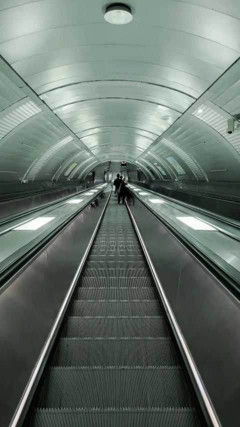 a long row of people riding on a luggage claim