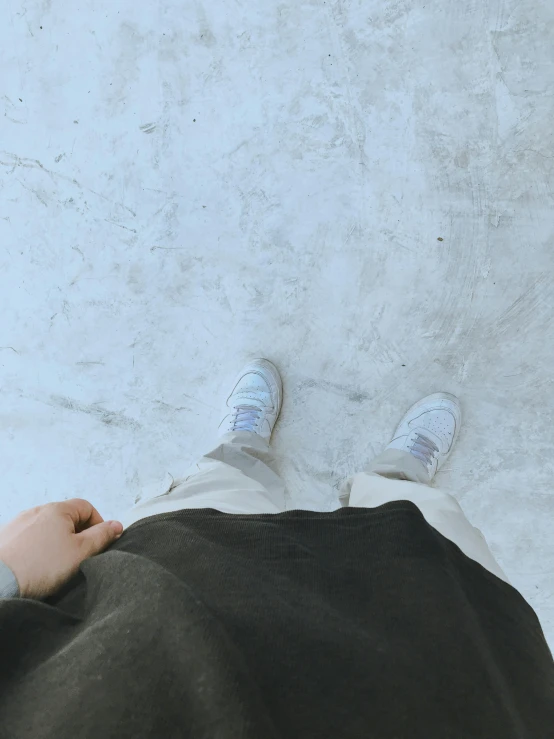 a person is standing next to the wall on top of a blanket