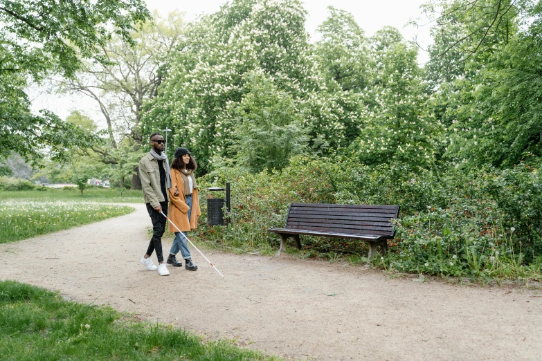 a man and a woman walking down a dirt road