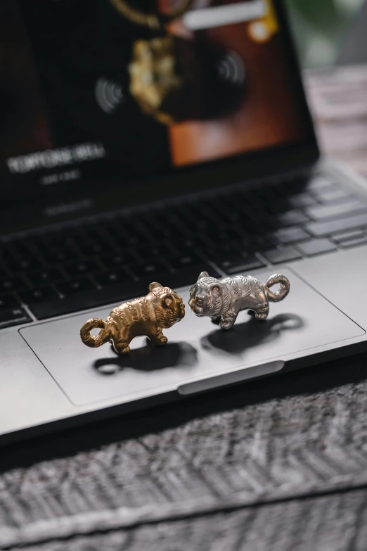 a couple of keys sitting on top of a laptop