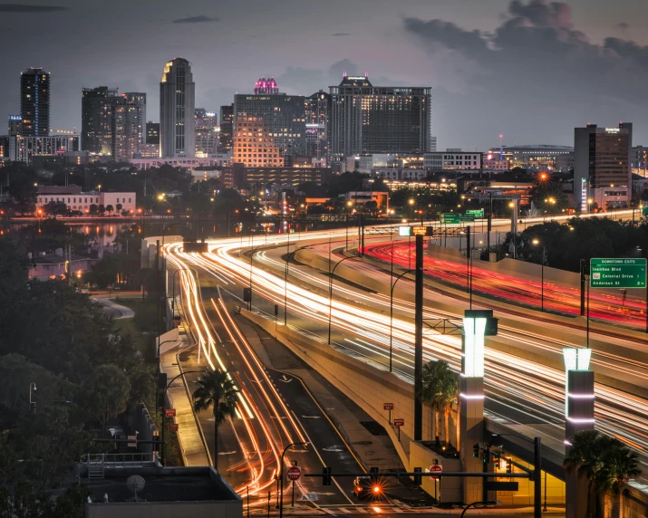 a view of traffic driving through a downtown area