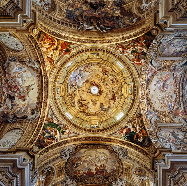 several large painted ceilings inside of an elaborate building