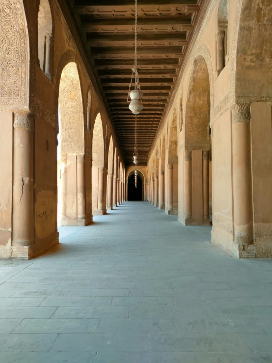 a long walkway in an enclosed area between buildings