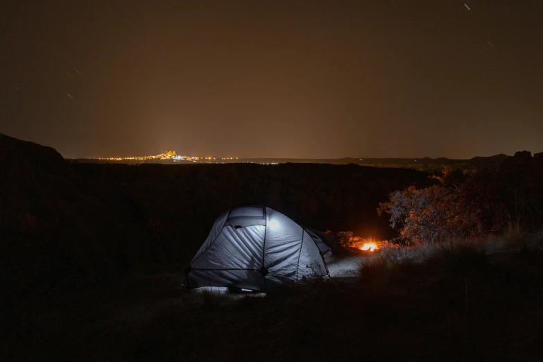 a dark picture with a tent in the ground