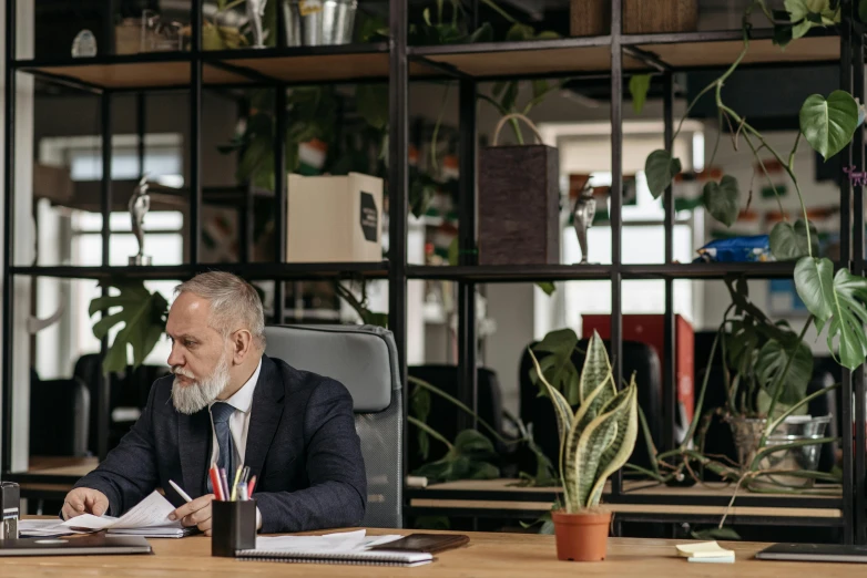 a man is sitting at a desk in an office