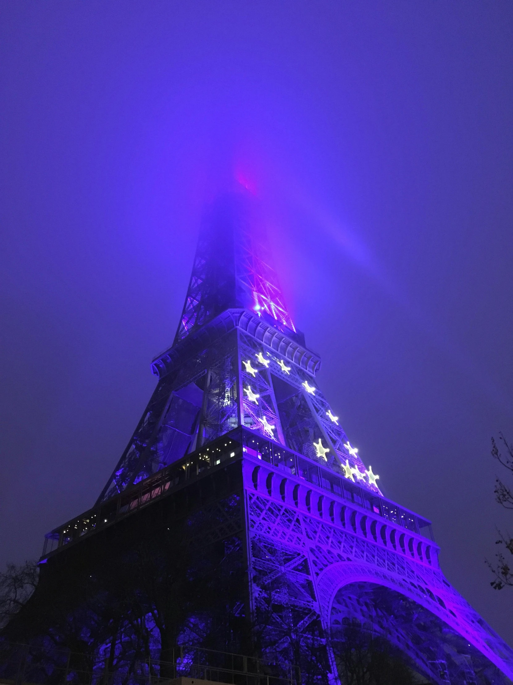 the tower is illuminated up with purple lights