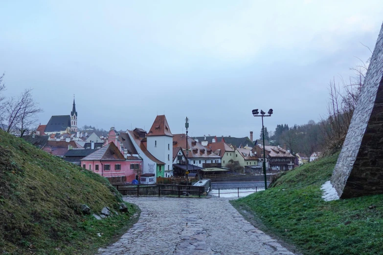 a small cobble stone road leads to the city