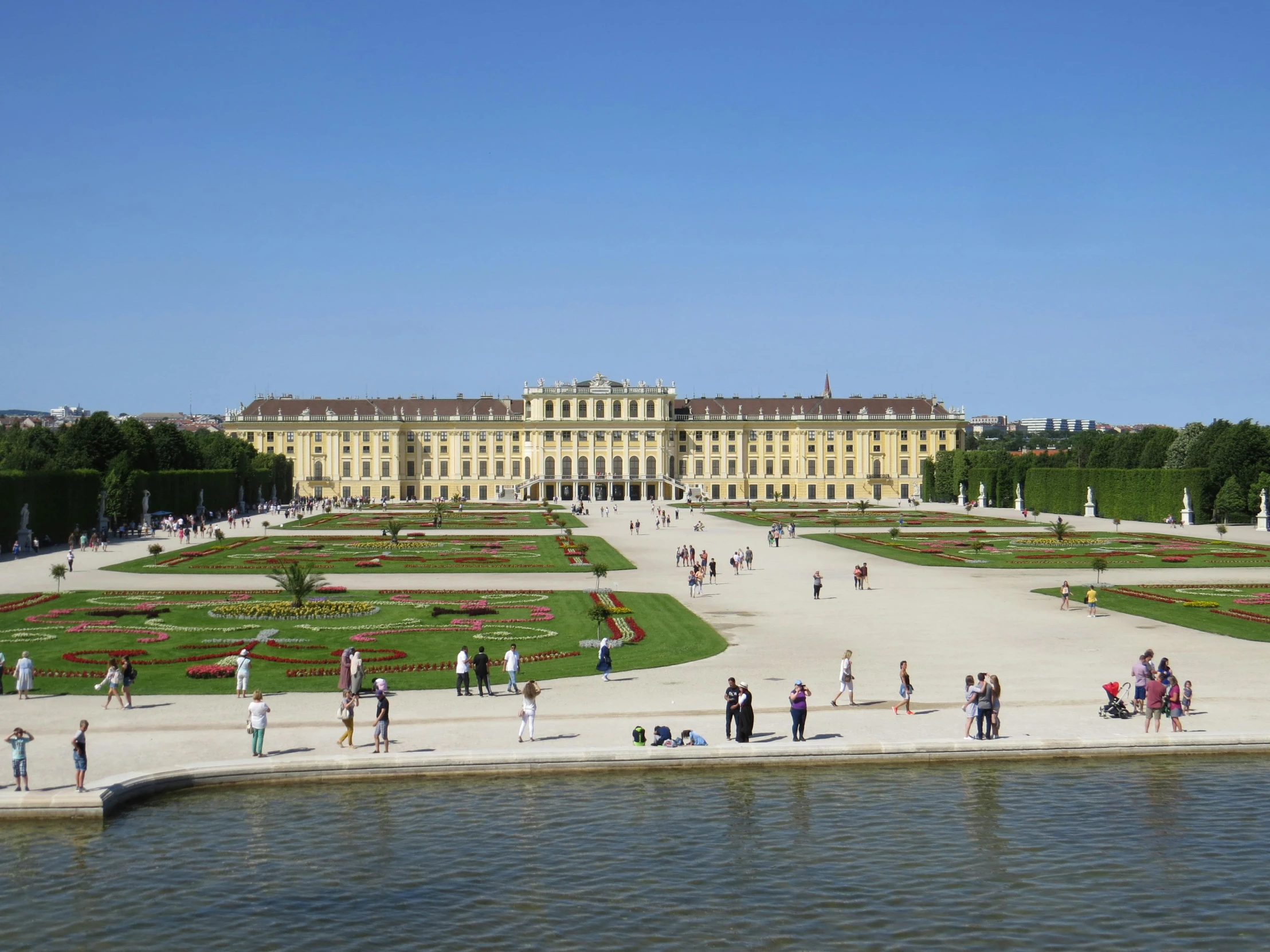 people standing around in front of a large building