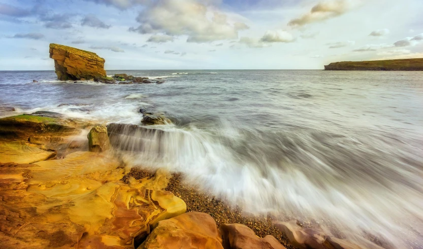 an artistic po of waves coming on the beach