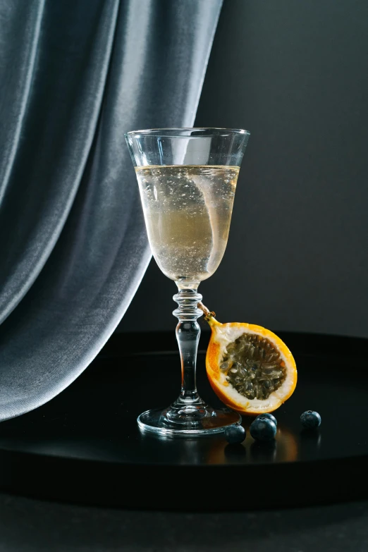 a glass filled with some kind of drink on a table