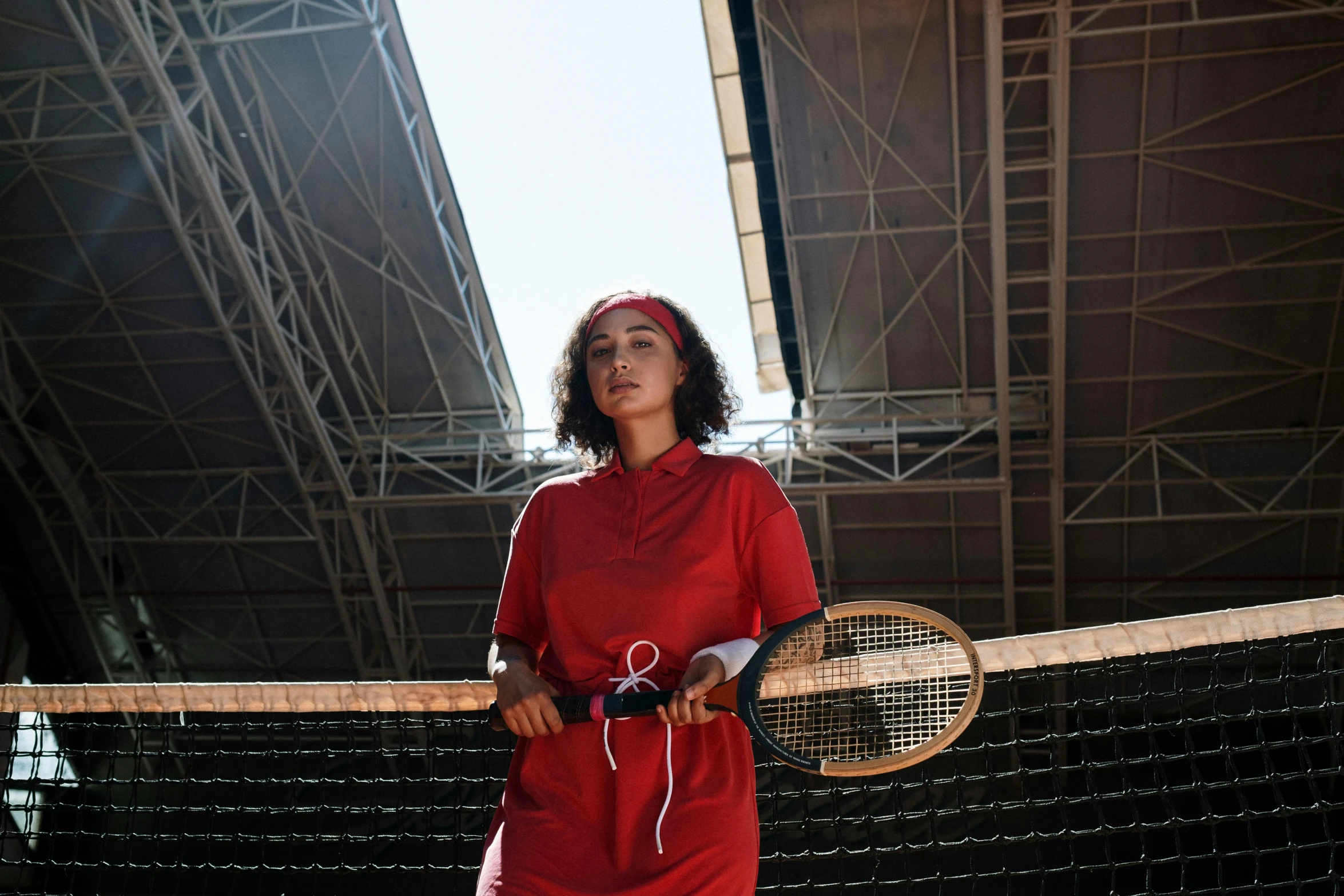 a woman holding a tennis racquet in one hand