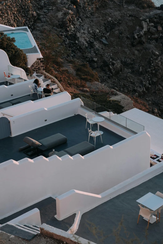 an aerial view of a house on a cliff overlooking the ocean