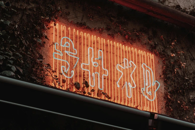 a large yellow neon sign above the sidewalk