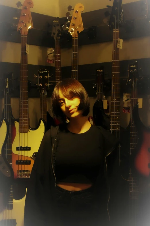 woman standing in front of guitars in a recording room