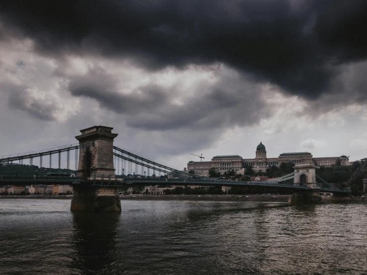 a po from across the water to a building with an overhang and stormy skies