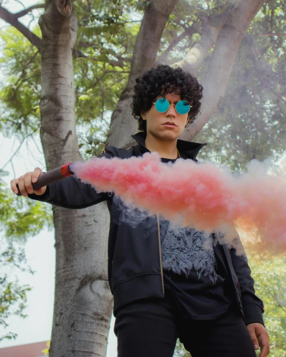 a man holding onto a pink substance with glasses