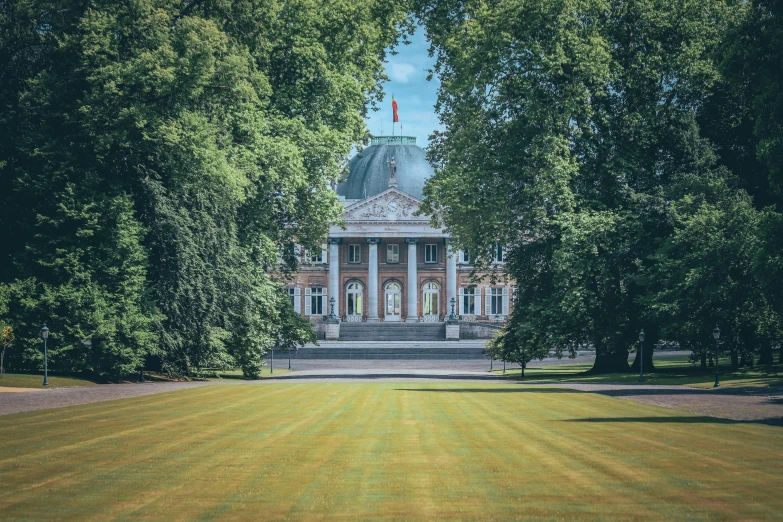 a large building with columns is surrounded by trees