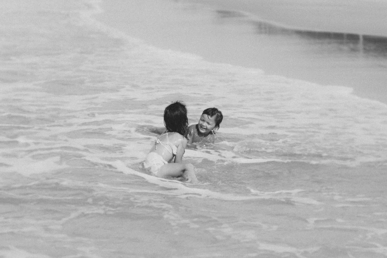 a couple of people riding on top of a surfboard in the ocean