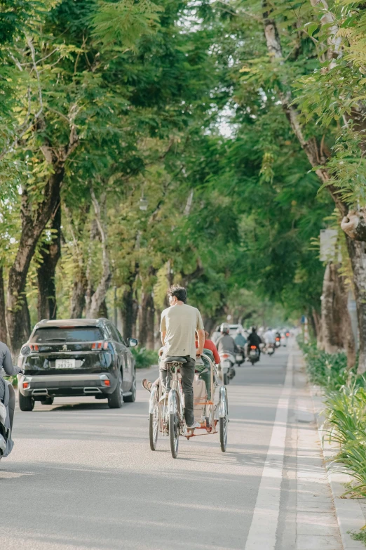 two people on bicycles with bicycles are seen on the street