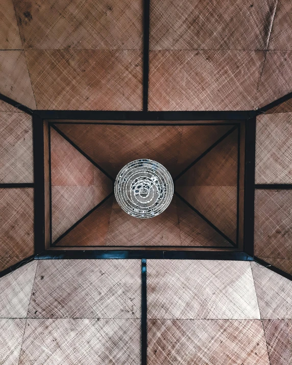 the interior wall, looking down, has wood paneling and a ceiling made up of several pieces of material