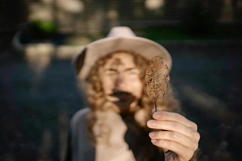 a woman that is holding a straw in her hand