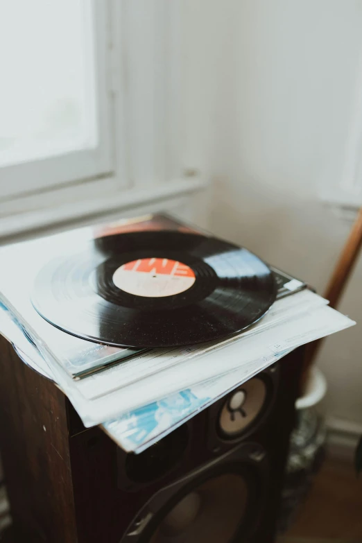 a record sitting on top of newspapers next to a window