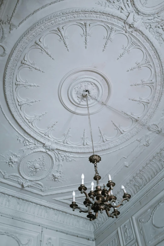 the chandelier in a ceiling has many candles