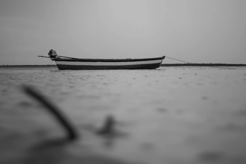 a boat sitting in the middle of a body of water