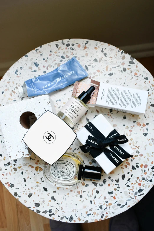 an arrangement of cosmetic and handbags are on the table