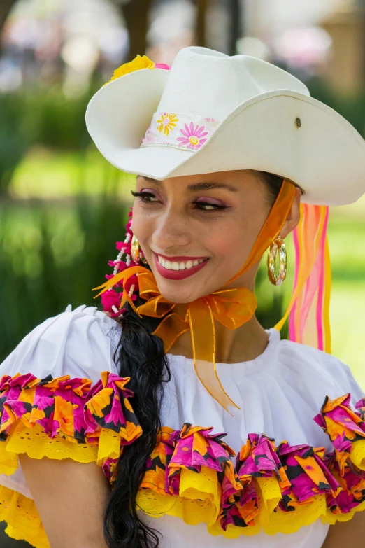 a woman wearing a white hat with flowers