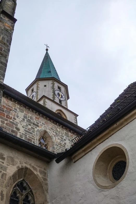 a building with arched windows and a church clock on top