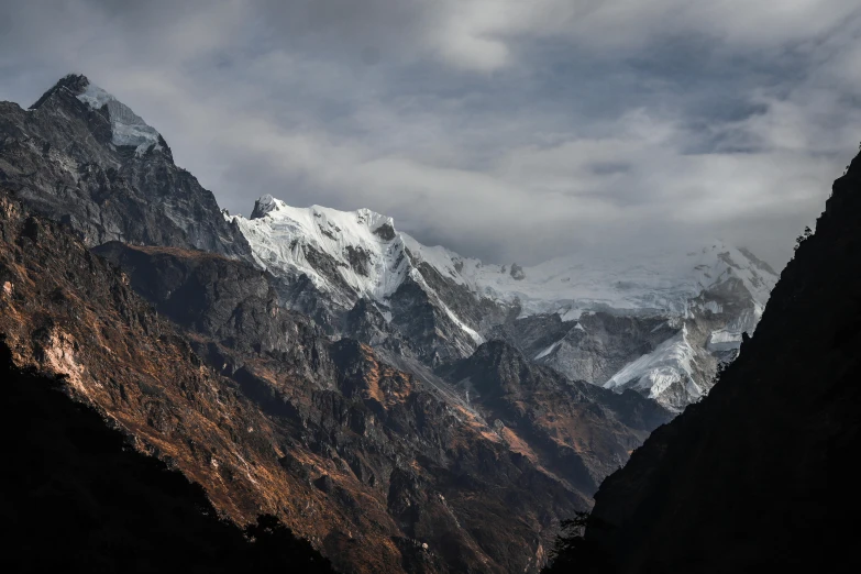 a mountain range under clouds with no one in it