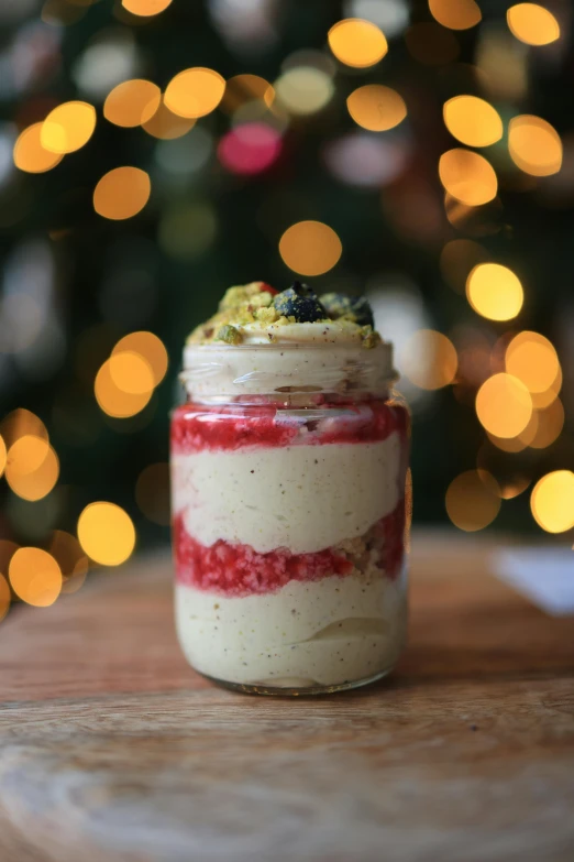 a glass jar containing food on a table next to lights