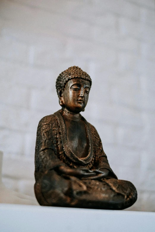 an ornate black buddha statue on display in a room