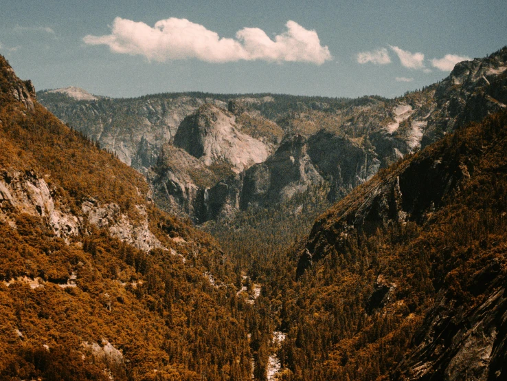 an orange valley surrounded by hills and a mountain